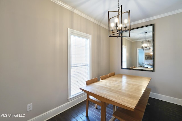 dining space with baseboards, plenty of natural light, an inviting chandelier, and crown molding