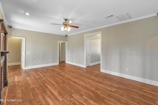 spare room featuring visible vents, ornamental molding, wood finished floors, baseboards, and ceiling fan