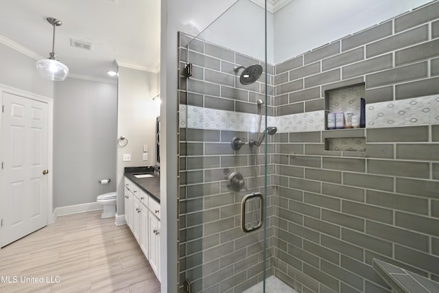 full bath with toilet, ornamental molding, a shower stall, baseboards, and vanity