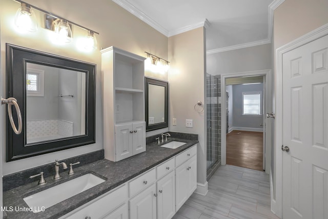 full bathroom featuring crown molding, walk in shower, double vanity, and a sink