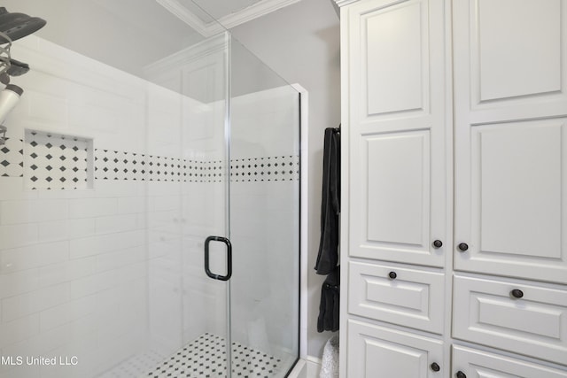 full bath with a shower stall and ornamental molding