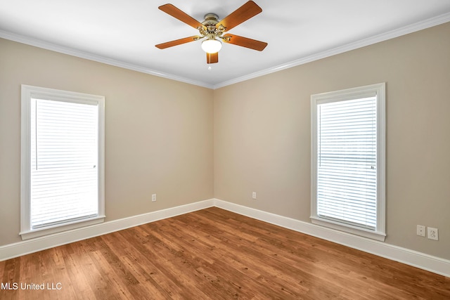 unfurnished room featuring ornamental molding, baseboards, ceiling fan, and wood finished floors