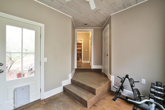 interior space with wooden ceiling, crown molding, baseboards, and ceiling fan