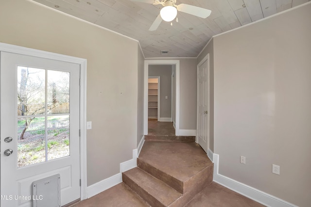 entryway featuring visible vents, concrete floors, crown molding, baseboards, and a ceiling fan