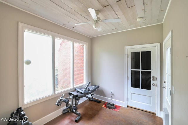 exercise area with baseboards, ceiling fan, and wooden ceiling