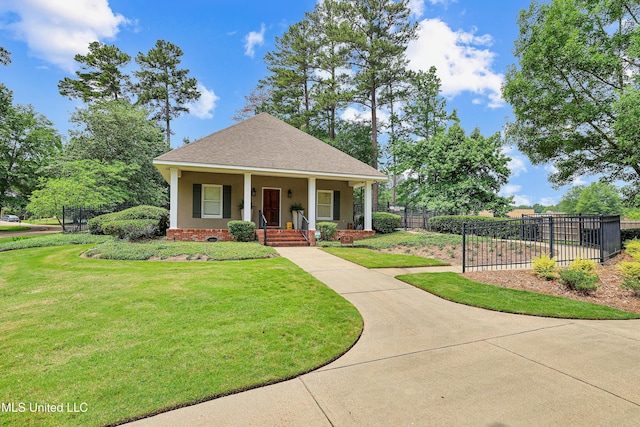 view of front facade with stucco siding, roof with shingles, a front yard, and fence