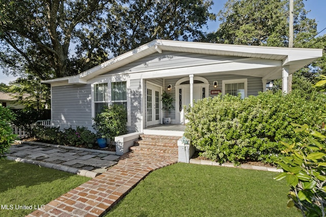 view of front of home with a porch and a front lawn