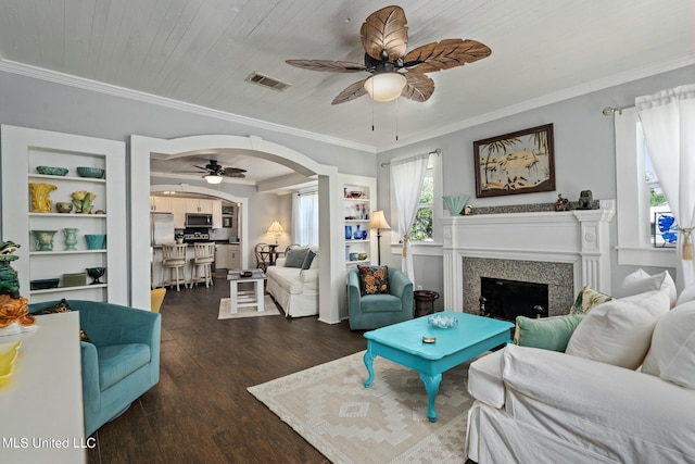 813 42nd Ave, Gulfport, MS 39501 - living area with ceiling fan, dark wood finished floors, a fireplace, ornamental molding, and arched walkways