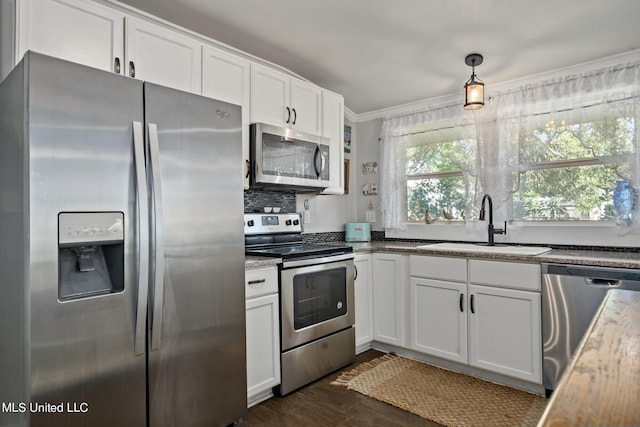 813 42nd Ave, Gulfport, MS 39501 - kitchen featuring stainless steel appliances, a sink, white cabinetry, dark wood-type flooring, and ornamental molding