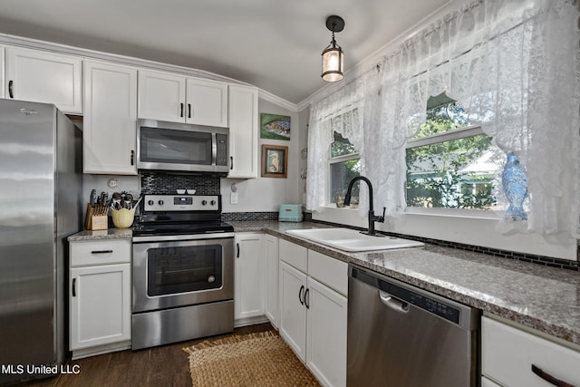 813 42nd Ave, Gulfport, MS 39501 - kitchen with stainless steel appliances, a sink, white cabinetry, dark wood finished floors, and hanging light fixtures
