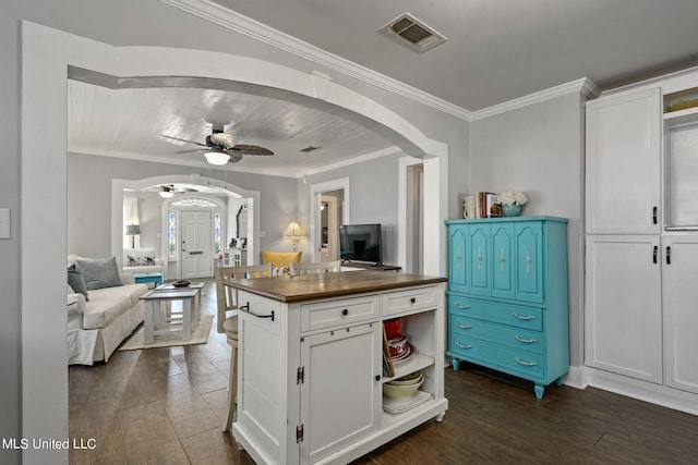 813 42nd Ave, Gulfport, MS 39501 - kitchen with arched walkways, dark wood-style floors, open shelves, white cabinetry, and crown molding