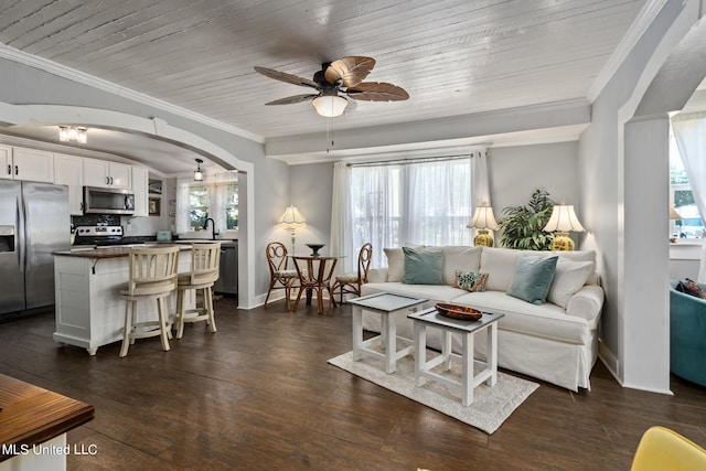 living room with dark hardwood / wood-style flooring, wood ceiling, ceiling fan, and a wealth of natural light