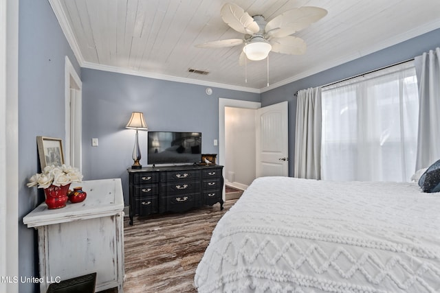 bedroom featuring ornamental molding, dark wood-type flooring, wooden ceiling, and ceiling fan