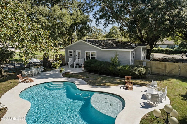 view of pool featuring a patio area and an outbuilding