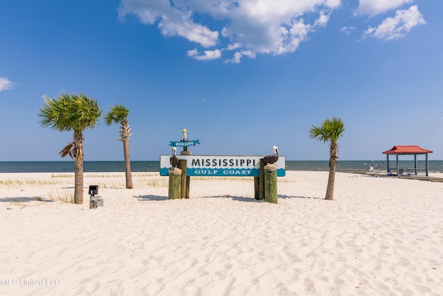 view of property's community featuring a water view, a gazebo, and a beach view