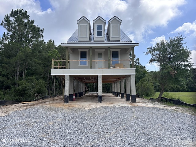 200 Farrar Ln, Waveland, MS 39576 - beach home featuring a carport, gravel driveway, and covered porch