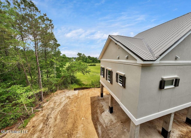 200 Farrar Ln, Waveland, MS 39576 - view of home's exterior with metal roof, a standing seam roof, and stucco siding