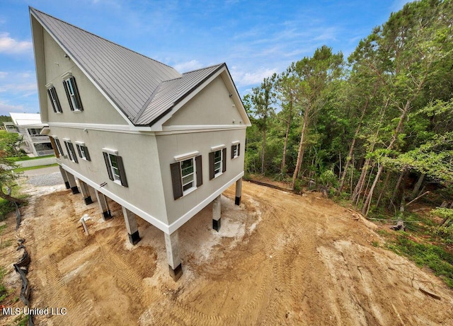 200 Farrar Ln, Waveland, MS 39576 - view of side of property featuring metal roof, a standing seam roof, and stucco siding