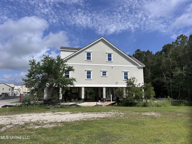 200 Farrar Ln, Waveland, MS 39576 - back of house with stucco siding and a yard