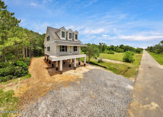 200 Farrar Ln, Waveland, MS 39576 - view of front facade featuring driveway and a porch