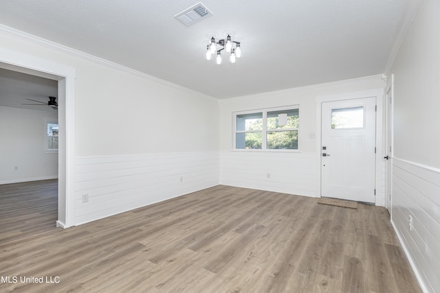 entryway with crown molding, light hardwood / wood-style flooring, and ceiling fan