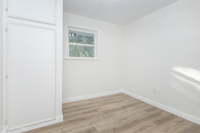 spare room with light wood-type flooring