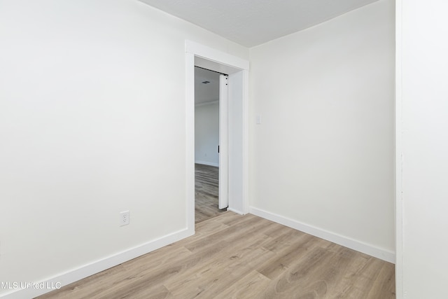 spare room featuring light wood-type flooring