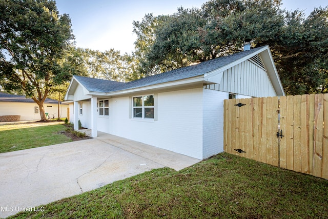 view of home's exterior with a yard and a patio