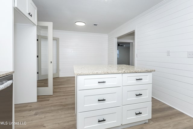 kitchen featuring dishwasher, white cabinets, light stone counters, and light hardwood / wood-style flooring