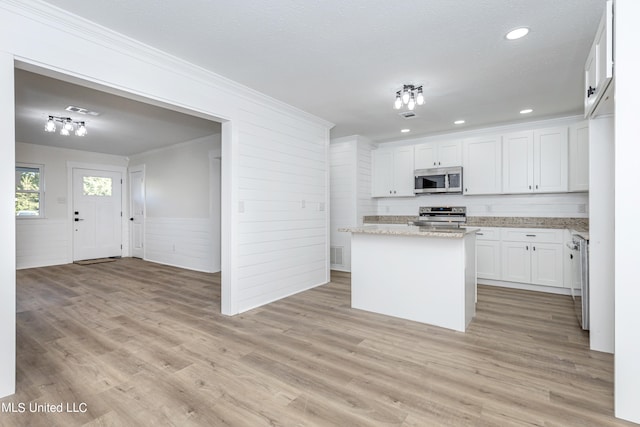 kitchen featuring a center island, white cabinetry, light hardwood / wood-style flooring, and stainless steel appliances