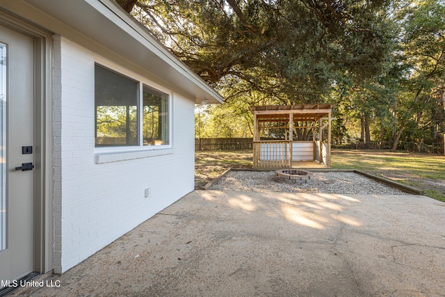 view of patio with a pergola and an outdoor fire pit