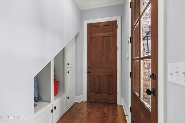 mudroom featuring crown molding, dark wood-style flooring, and baseboards
