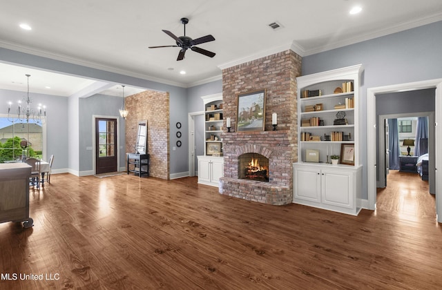 unfurnished living room with visible vents, wood finished floors, a fireplace, baseboards, and ceiling fan with notable chandelier