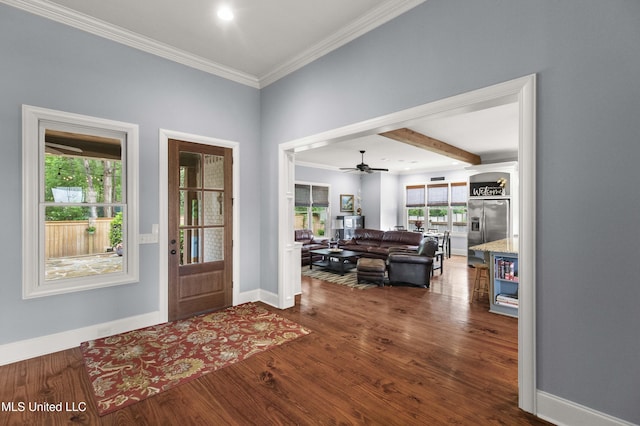 foyer with crown molding, dark wood-style flooring, and baseboards