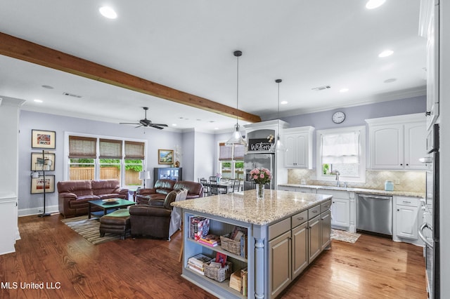 kitchen featuring a sink, white cabinets, stainless steel appliances, and open floor plan