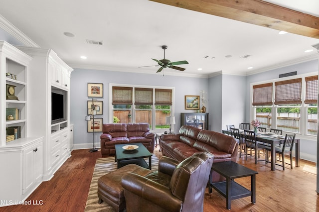 living room featuring visible vents, a ceiling fan, plenty of natural light, and crown molding
