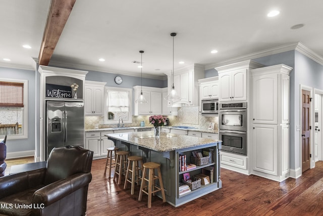 kitchen featuring open shelves, a center island, white cabinets, a sink, and stainless steel appliances