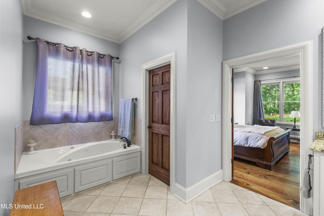 bathroom with tile patterned floors, ornamental molding, a whirlpool tub, and ensuite bath