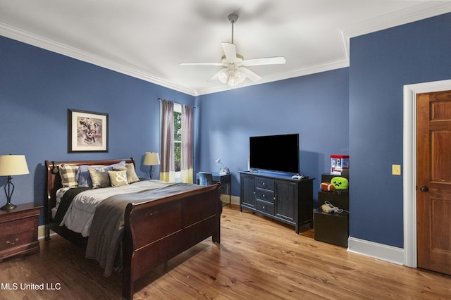 bedroom featuring baseboards, ornamental molding, and wood finished floors