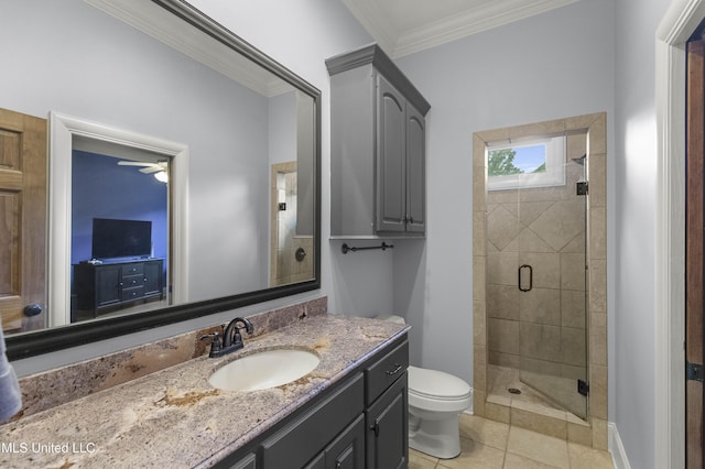 full bathroom featuring a stall shower, vanity, tile patterned floors, toilet, and ornamental molding