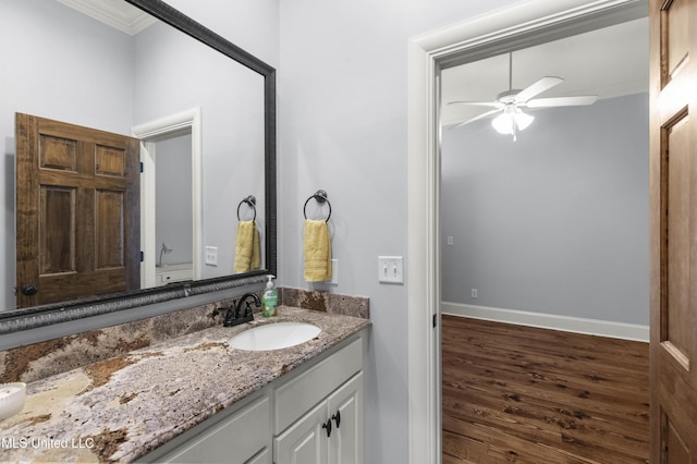 bathroom featuring vanity, crown molding, ceiling fan, and wood finished floors