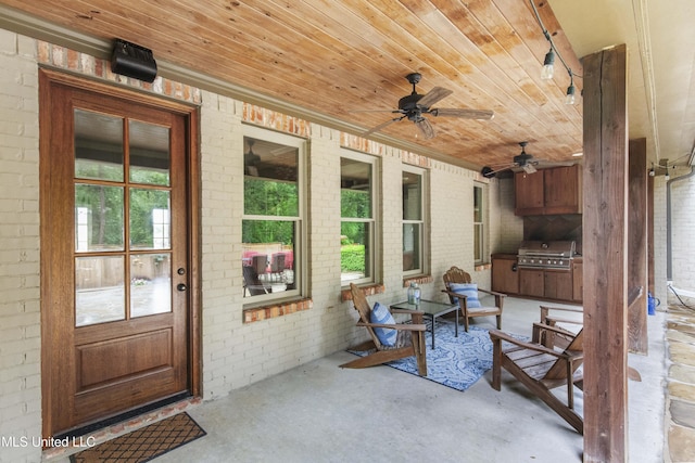 view of patio featuring area for grilling, exterior kitchen, and ceiling fan