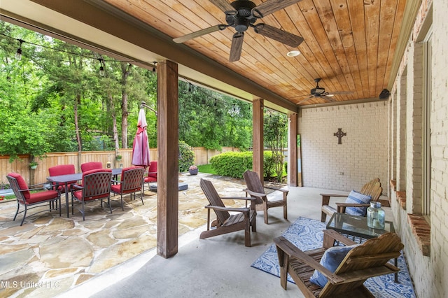 view of patio with a fenced backyard, ceiling fan, and outdoor dining space