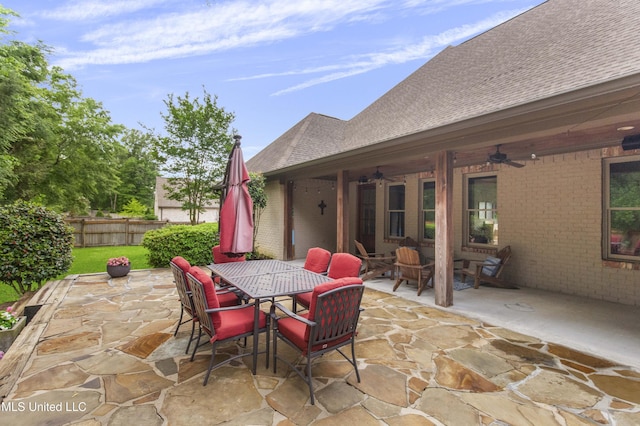 view of patio featuring fence, a ceiling fan, and outdoor dining area
