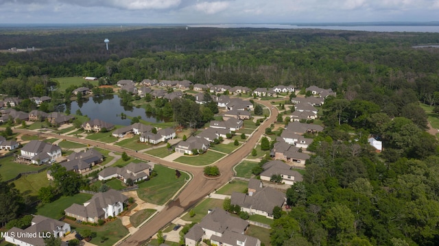 aerial view with a residential view, a water view, and a wooded view