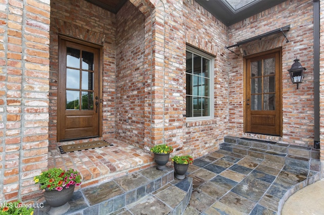 entrance to property with brick siding