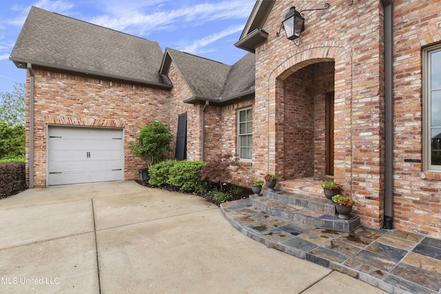 view of front of house featuring roof with shingles, driveway, and brick siding