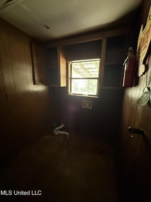 unfurnished bedroom featuring wooden walls