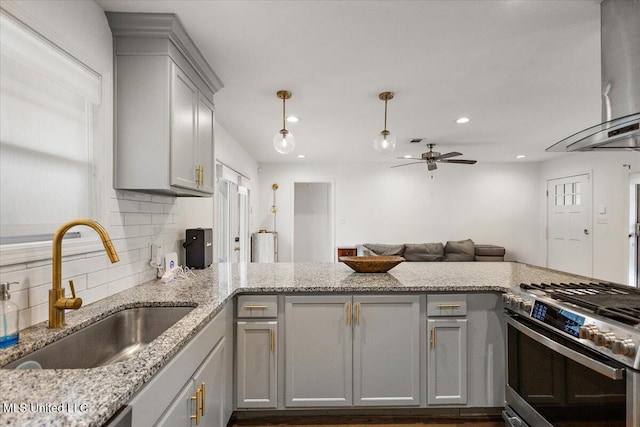 kitchen with gas stove, gray cabinets, ceiling fan, and sink