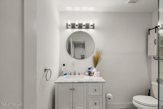 bathroom featuring vanity and toilet